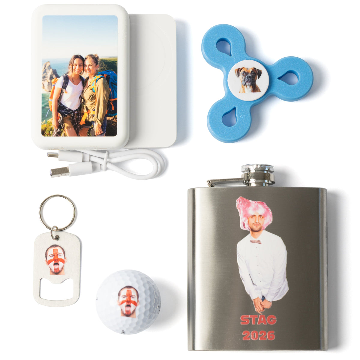 A set of personalized novelty items on a white background, including a custom photo electric nose sticker, a blue fidget spinner with a dog photo, a stainless steel flask with a custom portrait and 'STAD 2026' text, a white bottle opener keychain with a face cutout, a white golf ball with a face cutout, and a white USB charging cable.