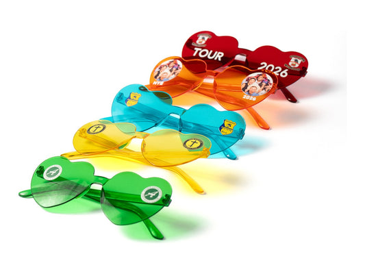 Five pairs of custom heart party glasses in different colours, printed with TOUR 2026 and club crests